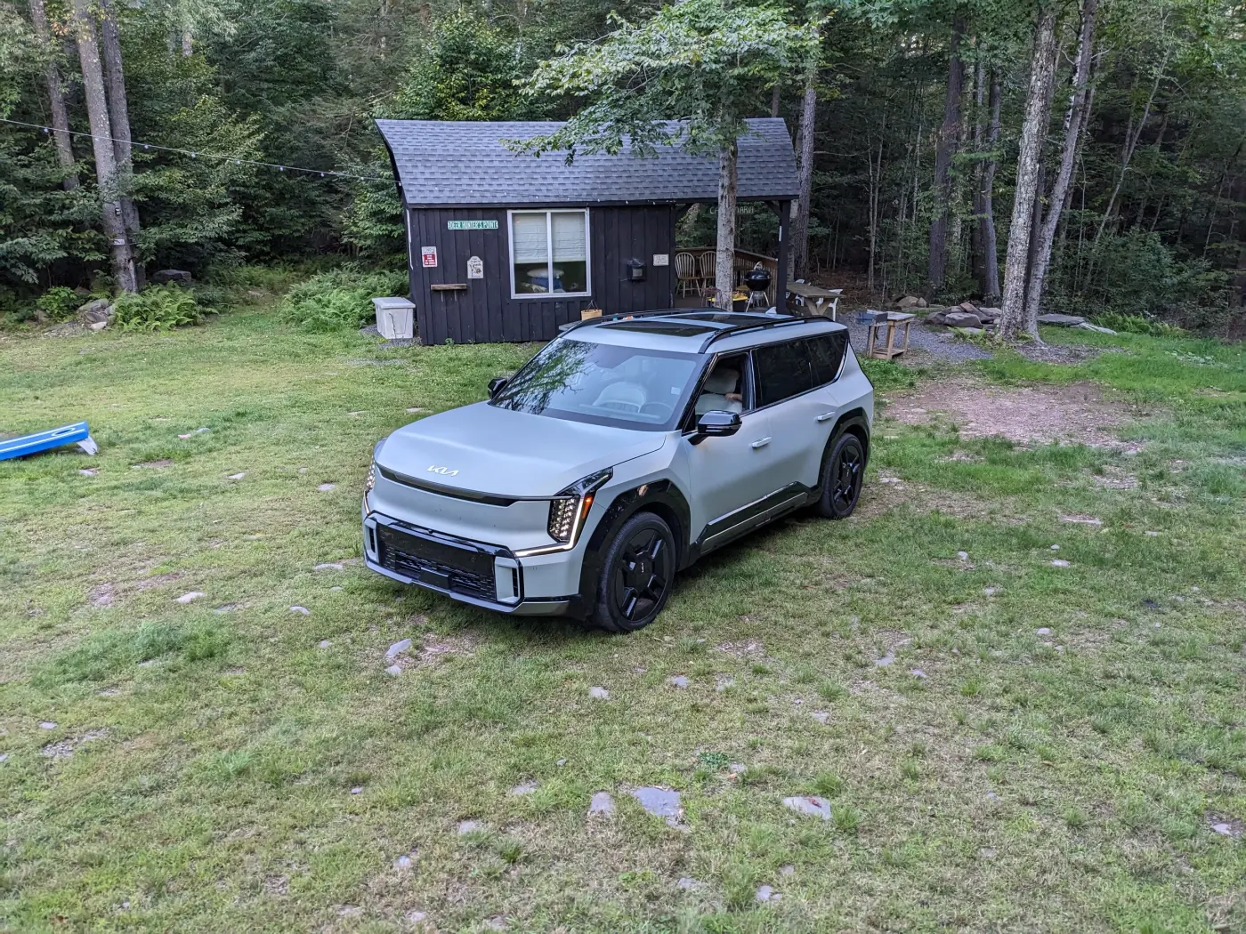 2024 Kia EV9 GT-Line parked beside a cabin at a Catskills campsite