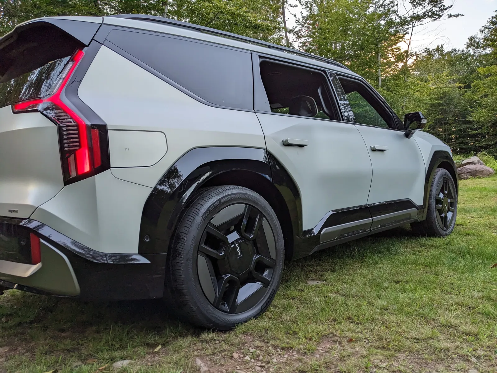 Rear three-quarter view of the Kia EV9 GT-Line showing the vertical tail lights and black alloy wheels
